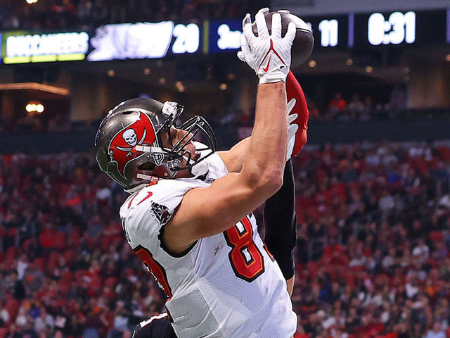 ATLANTA, GEORGIA - DECEMBER 05: Rob Gronkowski #87 of the Tampa Bay Buccaneers catches a touchdown pass against the Atlanta Falcons during the third quarter at Mercedes-Benz Stadium on December 05, 2021 in Atlanta, Georgia.