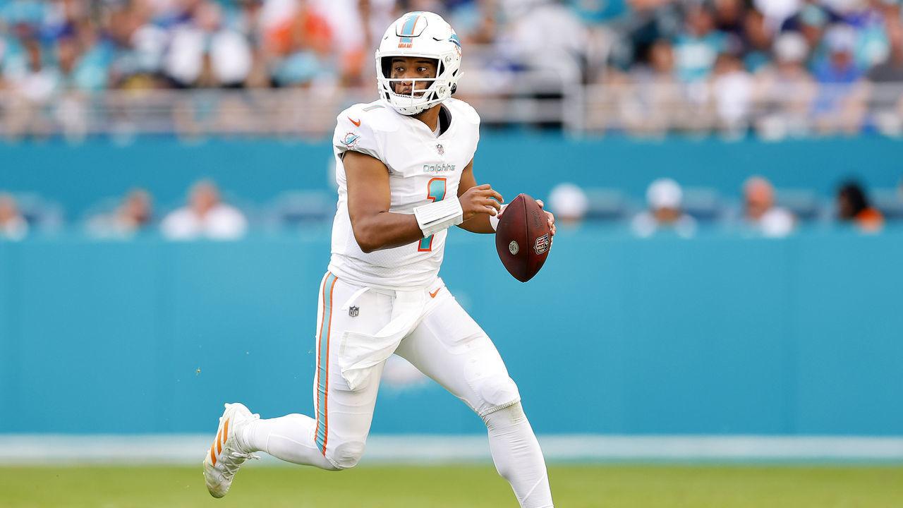 MIAMI GARDENS, FLORIDA - DECEMBER 05: Tua Tagovailoa #1 of the Miami Dolphins looks to make a pass play on the run against the New York Giants in the second quarter at Hard Rock Stadium on December 05, 2021 in Miami Gardens, Florida.