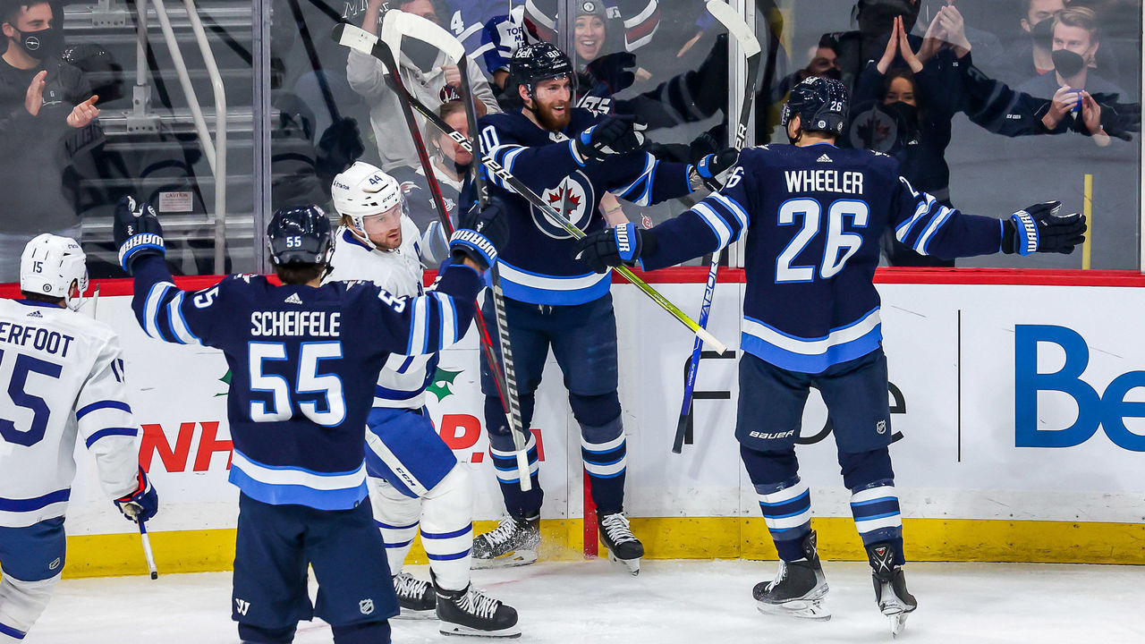 WINNIPEG, MB - DECEMBER 5: Mark Scheifele #55, Pierre-Luc Dubois #80 and Blake Wheeler #26 of the Winnipeg Jets celebrate a first period goal against the Toronto Maple Leafs at the Canada Life Centre on December 5, 2021 in Winnipeg, Manitoba, Canada.