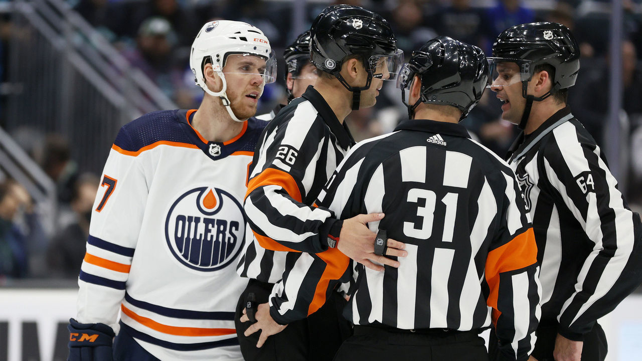 SEATTLE, WASHINGTON - DECEMBER 03: Connor McDavid #97 of the Edmonton Oilers talks with the referees against the Seattle Kraken during the third period at Climate Pledge Arena on December 03, 2021 in Seattle, Washington.