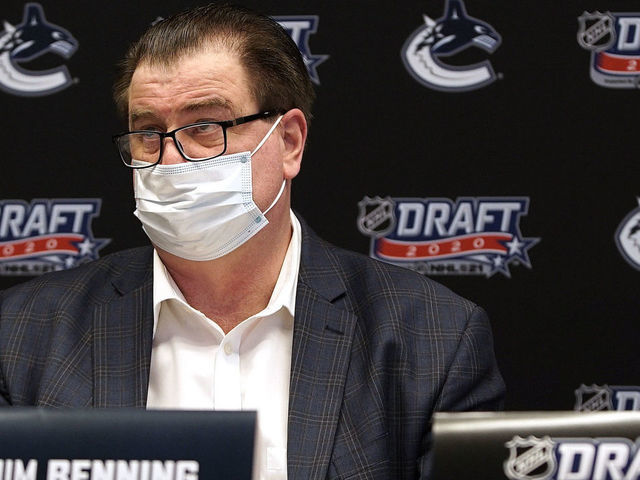 VANCOUVER, BC - OCTOBER 07: General manager Jim Benning of the Vancouver Canucks sits at the draft table during the rounds 2-7 of the 2020 NHL Entry Draft at Bell MTS Place on October 07, 2020 in Vancouver, British Columbia, Canada. The 2020 NHL Draft was held virtually due to the ongoing Coronavirus pandemic.