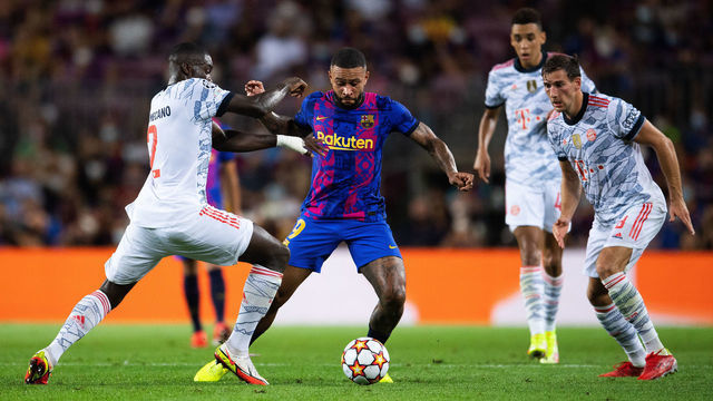 BARCELONA, SPAIN - SEPTEMBER 14: Memphis Depay of FC Barcelona competes for the ball with Dayot Upamecano and Leon Goretzka of Bayern München during the UEFA Champions League group E match between FC Barcelona and Bayern München at Camp Nou on September 14, 2021 in Barcelona, Spain.