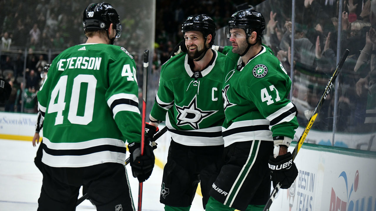 DALLAS, TX - DECEMBER 6: Jamie Benn #14 and Alexander Radulov #47 and Jacob Peterson #40 of the Dallas Stars celebrate a goal against the Arizona Coyotes at the American Airlines Center on December 6, 2021 in Dallas, Texas.