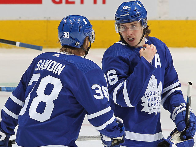 TORONTO, ON - MAY 6: Mitchell Marner #16 of the Toronto Maple Leafs gives direction to teammate Rasmus Sandin #38 late in action against the Montreal Canadiens during an NHL game at Scotiabank Arena on May 6, 2021 in Toronto, Ontario, Canada. The Maple Leafs defeated the Canadiens 5-2.