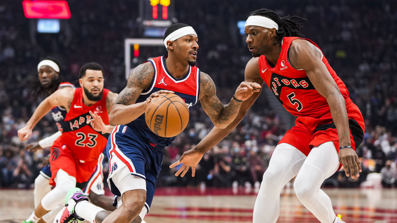 TORONTO, ON - DECEMBER 5: Bradley Beal #3 of the Washington Wizards drives against Precious Achiuwa #5 of the Toronto Raptors during the first half of their basketball game at the Scotiabank Arena on December 5, 2021 in Toronto, Ontario, Canada. NOTE TO USER: User expressly acknowledges and agrees that, by downloading and/or using this Photograph, user is consenting to the terms and conditions of the Getty Images License Agreement.
