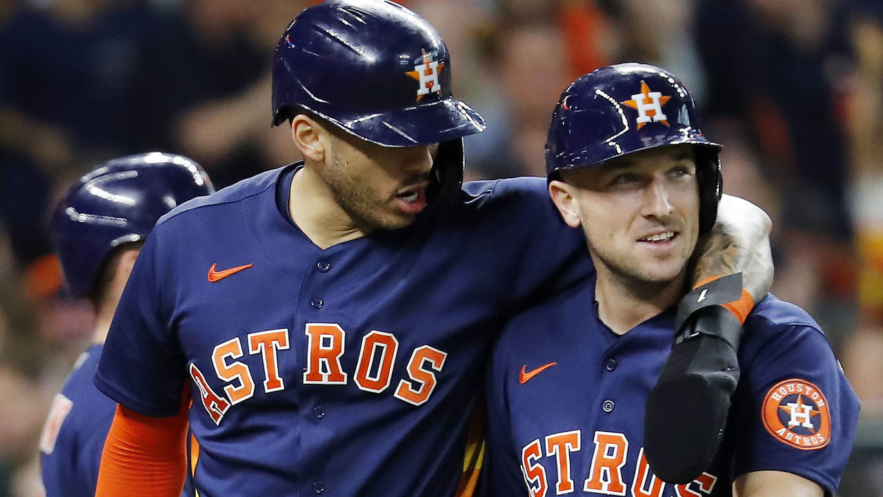 HOUSTON, TEXAS - MAY 16: Carlos Correa #1 of the Houston Astros and Alex Bregman #2 after scoring on a single by Chas McCormick #20 in the eighth inning against the Texas Rangers at Minute Maid Park on May 16, 2021 in Houston, Texas.