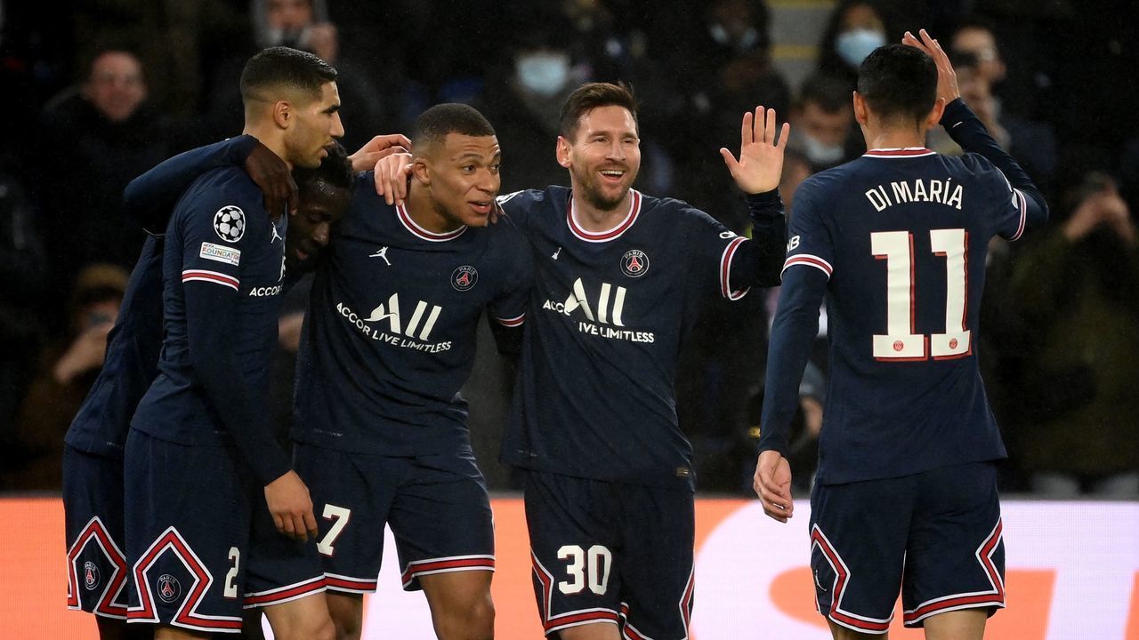 Paris Saint-Germain's Argentinian forward Lionel Messi (2nd R) is congratulated by team mates after scoring a goal during the UEFA Champions League first round day 6 Group A football match between Paris Saint-Germain (PSG) and Club Brugge, at the Parc des Princes stadium in Paris on December 7, 2021.