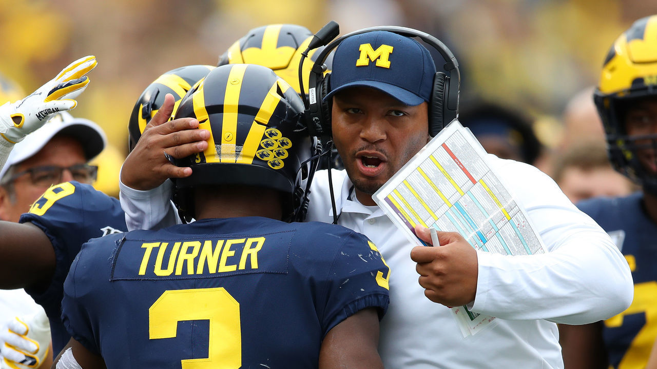 ANN ARBOR, MICHIGAN - SEPTEMBER 28: Christian Turner #3 of the Michigan Wolverines celebrates his third quarter touchdown with offensive coordinator Josh Gattis while playing the Rutgers Scarlet Knights at Michigan Stadium on September 28, 2019 in Ann Arbor, Michigan.