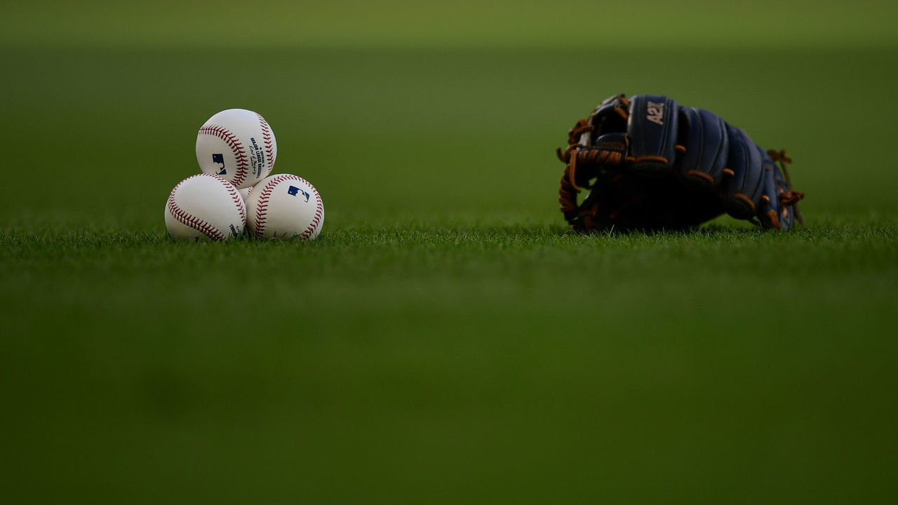 ATLANTA, GA - SEPTEMBER 09: Baseballs and a glove on the field before a game between the Washington Nationals and the Atlanta Braves at Truist Park on September 9, 2021 in Atlanta, Georgia.