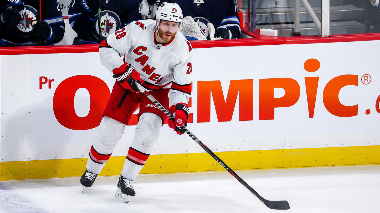 WINNIPEG, MB - DECEMBER 7: Ian Cole #28 of the Carolina Hurricanes plays the puck during second period action against the Winnipeg Jets at the Canada Life Centre on December 7, 2021 in Winnipeg, Manitoba, Canada.