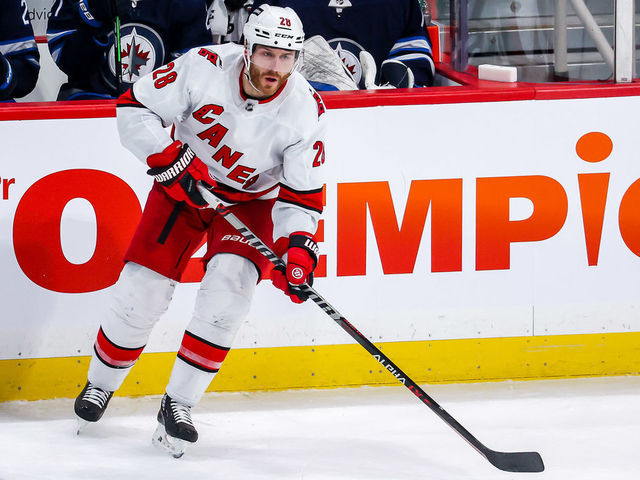 WINNIPEG, MB - DECEMBER 7: Ian Cole #28 of the Carolina Hurricanes plays the puck during second period action against the Winnipeg Jets at the Canada Life Centre on December 7, 2021 in Winnipeg, Manitoba, Canada.