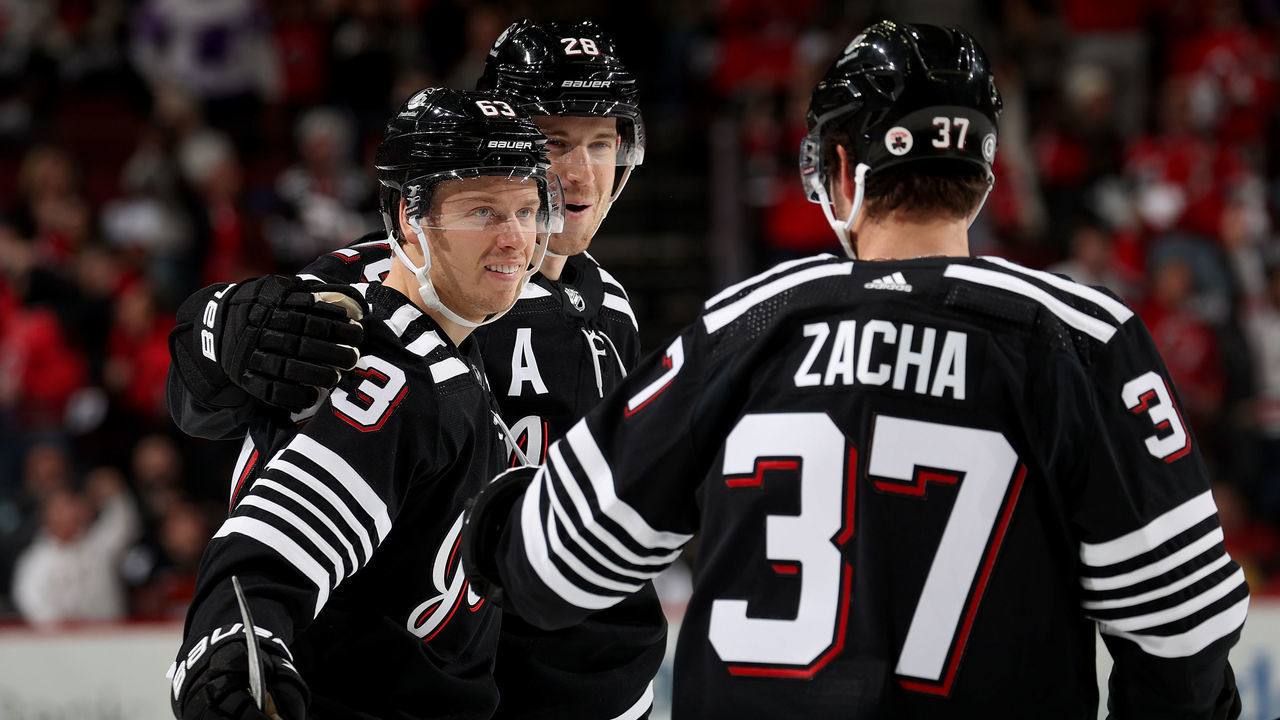 NEWARK, NEW JERSEY - DECEMBER 08: Jesper Bratt #63 of the New Jersey Devils is congratulated by teammates Damon Severson #28 and Pavel Zacha #37 after he scored during the second period against the Philadelphia Flyers at Prudential Center on December 08, 2021 in Newark, New Jersey. Tonight the New Jersey Devils are wearing their newly designed third jersey.