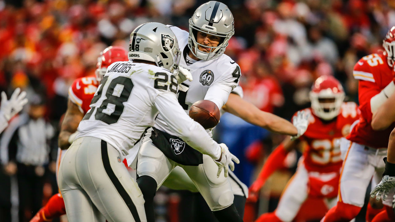 KANSAS CITY, MO - DECEMBER 01: Derek Carr #4 of the Oakland Raiders hands the football off to Josh Jacobs #28 of the Oakland Raiders during the game against the Kansas City Chiefs at Arrowhead Stadium on December 1, 2019 in Kansas City, Missouri.