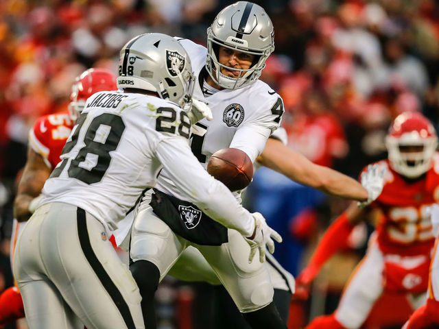 KANSAS CITY, MO - DECEMBER 01: Derek Carr #4 of the Oakland Raiders hands the football off to Josh Jacobs #28 of the Oakland Raiders during the game against the Kansas City Chiefs at Arrowhead Stadium on December 1, 2019 in Kansas City, Missouri.