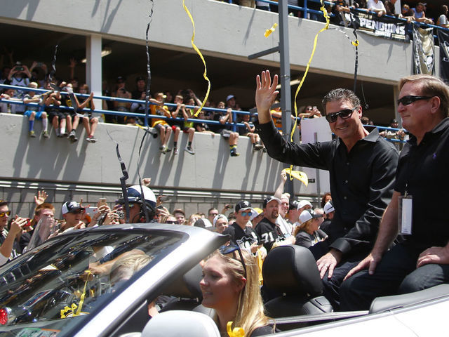 PITTSBURGH, PA - JUNE 15: Mario Lemieux and Ron Burkle celebrate during the Victory Parade and Rally on June 15, 2016 in Pittsburgh, Pennsylvania.