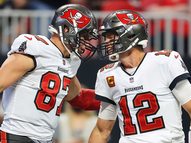 ATLANTA, GEORGIA - DECEMBER 05: (EDITOR'S NOTE: Alternate crop) Rob Gronkowski #87 of the Tampa Bay Buccaneers celebrates his touchdown against the Atlanta Falcons with teammate Tom Brady #12 during the second quarter at Mercedes-Benz Stadium on December 05, 2021 in Atlanta, Georgia.