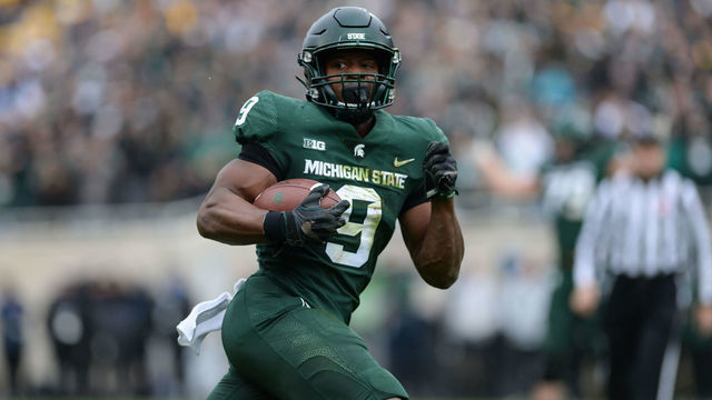 EAST LANSING, MI - OCTOBER 30: Michigan State Spartans running back Kenneth Walker (9) checks to see if the Michigan defense can catch him during a college football game between the Michigan State Spartans and the Michigan Wolverines on October 30, 2021 at Spartan Stadium in East Lansing, MI.