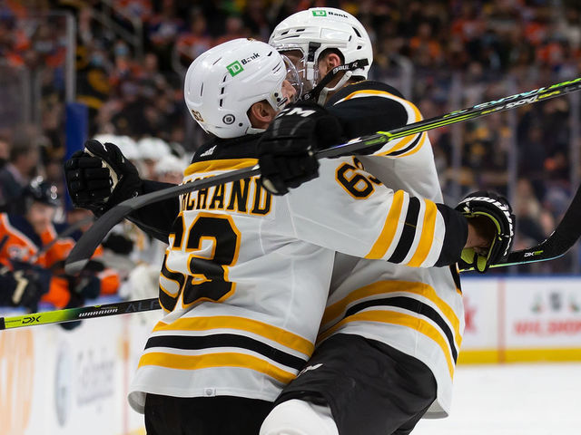 EDMONTON, AB - DECEMBER 09: Brad Marchand #63 and Patrice Bergeron #37 of the Boston Bruins celebrate a goal against the Edmonton Oilers during the first period at Rogers Place on December 9, 2021 in Edmonton, Canada.