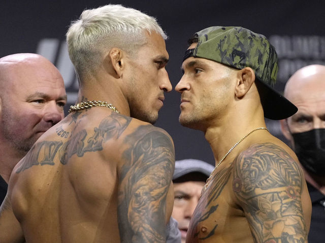 LAS VEGAS, NEVADA - DECEMBER 10: (L-R) Opponents Charles Oliveira of Brazil and Dustin Poirier face off during the UFC 269 ceremonial weigh-in at MGM Grand Garden Arena on December 10, 2021 in Las Vegas, Nevada.