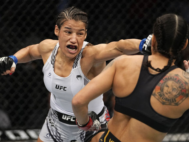 LAS VEGAS, NEVADA - DECEMBER 11: (L-R) Julianna Pena punches Amanda Nunes of Brazil in their UFC bantamweight championship bout during the UFC 269 on December 11, 2021 in Las Vegas, Nevada.