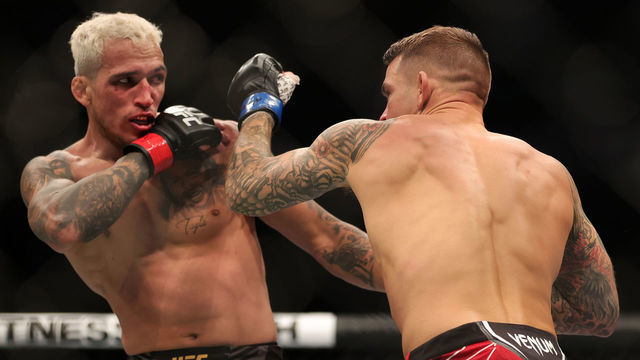 LAS VEGAS, NEVADA - DECEMBER 11: Dustin Poirier (R) exchanges strikes with Charles Oliveira of Brazil in their lightweight title fight during the UFC 269 event at T-Mobile Arena on December 11, 2021 in Las Vegas, Nevada.