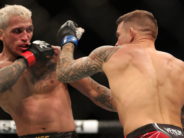 LAS VEGAS, NEVADA - DECEMBER 11: Dustin Poirier (R) exchanges strikes with Charles Oliveira of Brazil in their lightweight title fight during the UFC 269 event at T-Mobile Arena on December 11, 2021 in Las Vegas, Nevada.
