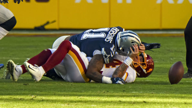 LANDOVER, MD - DECEMBER 12: Washington Football Team quarterback Taylor Heinicke (4) is hit by Dallas Cowboys outside linebacker Micah Parsons (11) and fumbles the ball during the NFL game between the Dallas Cowboys and the Washington Football Team on December 12, 2021 at Fed Ex Field in Landover, MD.