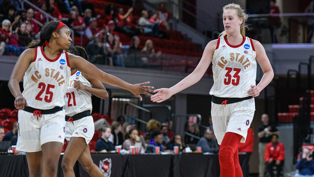 RALEIGH, NC - MARCH 23: NC State Wolfpack center Elissa Cunane (33) and NC State Wolfpack forward Kayla Jones (25) celebrate after the bucket during the 2019 Div 1 Women's Championship - First Round college basketball game between the Maine Black Bears and NC State Wolfpack on March 23, 2019, at Reynolds Coliseum in Raleigh, NC.