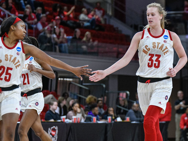 RALEIGH, NC - MARCH 23: NC State Wolfpack center Elissa Cunane (33) and NC State Wolfpack forward Kayla Jones (25) celebrate after the bucket during the 2019 Div 1 Women's Championship - First Round college basketball game between the Maine Black Bears and NC State Wolfpack on March 23, 2019, at Reynolds Coliseum in Raleigh, NC.