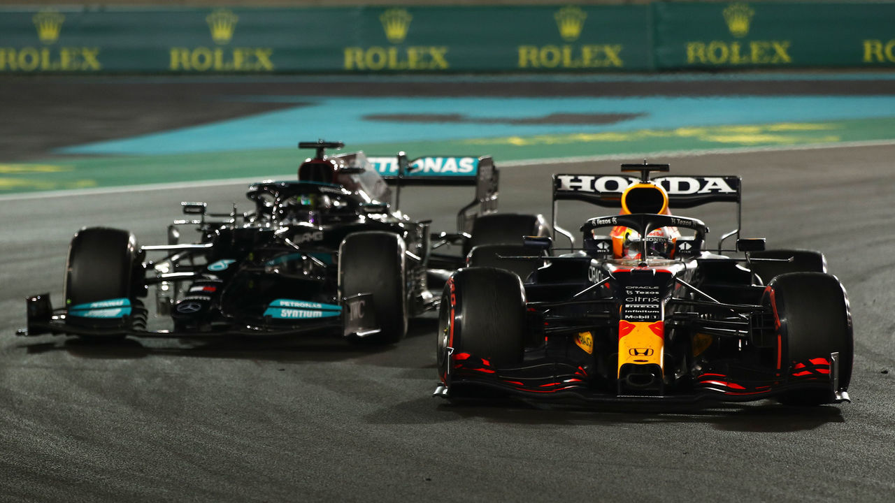 ABU DHABI, UNITED ARAB EMIRATES - DECEMBER 12: Max Verstappen of the Netherlands driving the (33) Red Bull Racing RB16B Honda leads Lewis Hamilton of Great Britain driving the (44) Mercedes AMG Petronas F1 Team Mercedes W12 during the F1 Grand Prix of Abu Dhabi at Yas Marina Circuit on December 12, 2021 in Abu Dhabi, United Arab Emirates.