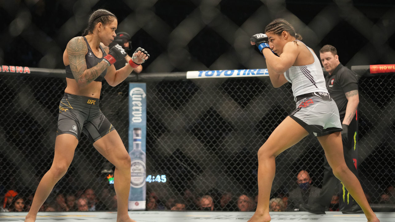 LAS VEGAS, NV - DECEMBER 11: (L-R) Amanda Nunes battles Julianna Peña in their womans bantamweight title fight during the UFC 269 on December 11, 2021, at T-Mobile Arena in Las Vegas, NV.