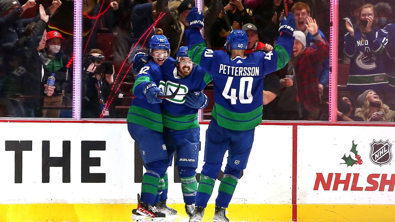 VANCOUVER, BC - DECEMBER 14: The Vancouver Canucks celebrate a goal by Vancouver Canucks Left Wing Vasily Podkolzin (92) against the Columbus Blue Jackets during their NHL game at Rogers Arena on December 14, 2021 in Vancouver, British Columbia, Canada.
