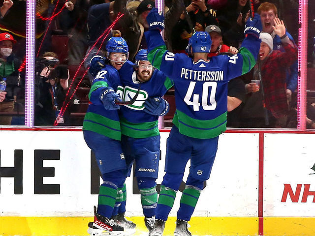 VANCOUVER, BC - DECEMBER 14: The Vancouver Canucks celebrate a goal by Vancouver Canucks Left Wing Vasily Podkolzin (92) against the Columbus Blue Jackets during their NHL game at Rogers Arena on December 14, 2021 in Vancouver, British Columbia, Canada.