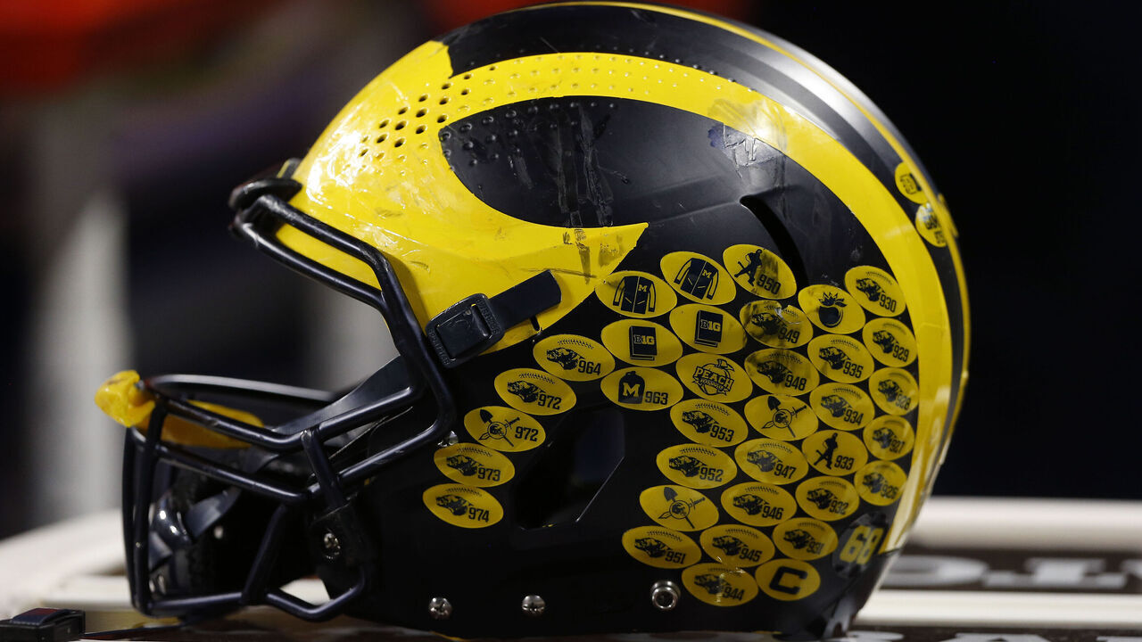 INDIANAPOLIS, IN - DECEMBER 04: A Michigan Wolverines helmet sits atop a table during the Big 10 Conference Championship between the Iowa Hawkeyes and Michigan Wolverines on December 04, 2021 at Lucas Oil Stadium in Indianapolis, IN.