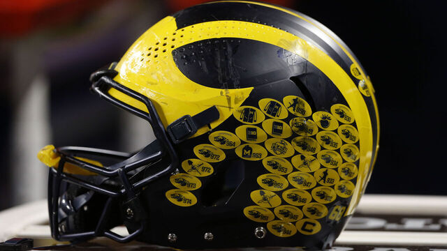 INDIANAPOLIS, IN - DECEMBER 04: A Michigan Wolverines helmet sits atop a table during the Big 10 Conference Championship between the Iowa Hawkeyes and Michigan Wolverines on December 04, 2021 at Lucas Oil Stadium in Indianapolis, IN.