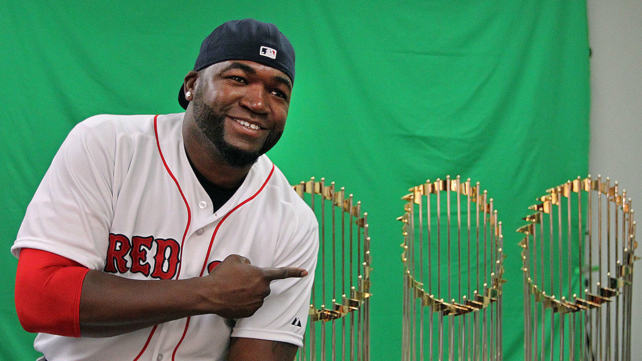 FORT MYERS, FL - FEBRUARY 23: It was Photo Day at camp today, as players came in early to pose for pictures for yearbooks, programs, and editorial use during Boston Red Sox spring training at JetBlue Park on Feb. 23, 2014. They also did videos and audio for promotional purposes during the season. Red Sox designated hitter David Ortiz posed with the 2004, 2007, and 2013 World Series trophies, all teams that he played on. After he did a traditional pose for the team photographer, he requested one just for himself, and he turned his cap around, sat on the table and pointed at the hardware.