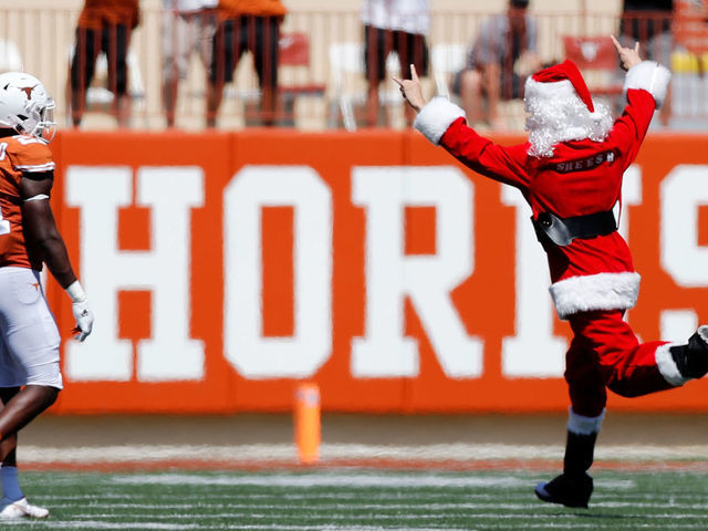AUSTIN, TEXAS - SEPTEMBER 25: A fan runs onto the field dressed as Santa Claus in the fourth quarter of the game between the Texas Longhorns and the Texas Tech Red Raiders at Darrell K Royal-Texas Memorial Stadium on September 25, 2021 in Austin, Texas.