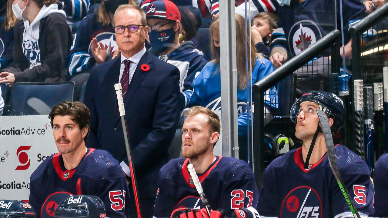WINNIPEG, MB - NOVEMBER 11: Head Coach Paul Maurice, Mark Scheifele #55, Nikolaj Ehlers #27 and Brenden Dillon #5 of the Winnipeg Jets look on from the bench prior to puck drop against the San Jose Sharks at the Canada Life Centre on November 11, 2021 in Winnipeg, Manitoba, Canada.