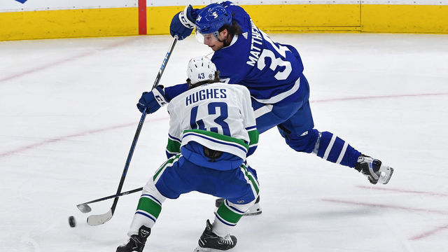 TORONTO, ON - MAY 01: Vancouver Canucks Defenceman Quinn Hughes (43) defends against Toronto Maple Leafs Center Auston Matthews (34) during the regular season NHL game between the Vancouver Canucks and Toronto Maple Leafs on May 1, 2021 at Scotabank Arena in Toronto, ON.