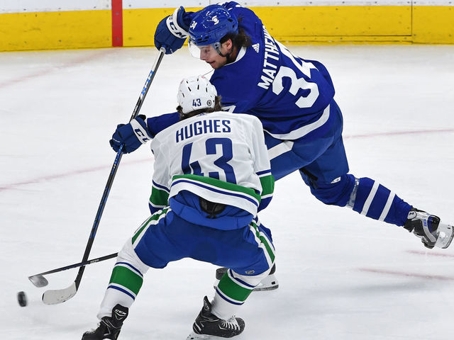 TORONTO, ON - MAY 01: Vancouver Canucks Defenceman Quinn Hughes (43) defends against Toronto Maple Leafs Center Auston Matthews (34) during the regular season NHL game between the Vancouver Canucks and Toronto Maple Leafs on May 1, 2021 at Scotabank Arena in Toronto, ON.