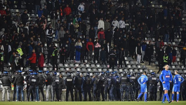 French anti-riot police are seen after a Nimes' supporter ran onto the pitch during the French Cup round-of-64 football match between JSCBA Nimes (R2) and Clermont (L1) at the Costieres stadium in Nimes, southern France, on December 18, 2021.
