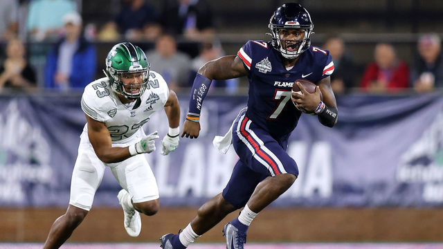 MOBILE, ALABAMA - DECEMBER 18: Malik Willis #7 of the Liberty Flames runs with the ball as Blake Bogan #23 of the Eastern Michigan Eagles defends during the first half of the LendingTree Bowl at Hancock Whitney Stadium on December 18, 2021 in Mobile, Alabama.