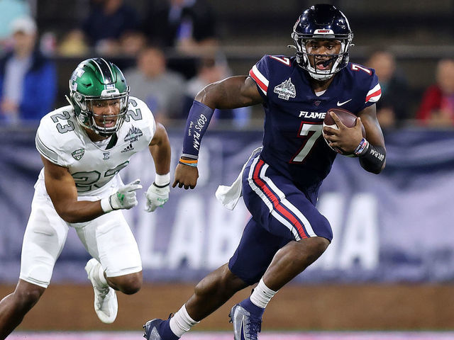 MOBILE, ALABAMA - DECEMBER 18: Malik Willis #7 of the Liberty Flames runs with the ball as Blake Bogan #23 of the Eastern Michigan Eagles defends during the first half of the LendingTree Bowl at Hancock Whitney Stadium on December 18, 2021 in Mobile, Alabama.