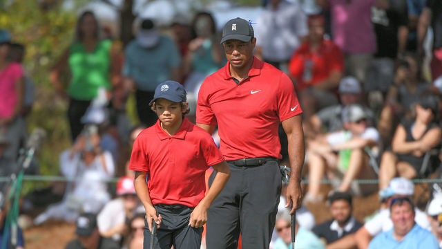 ORLANDO, FL - DECEMBER 19: Tiger Woods and his son, Charlie Woods, read the ninth green during the final round of the PGA TOUR Champions PNC Championship at Ritz-Carlton Golf Club on December 19, 2021 in Orlando, Florida.