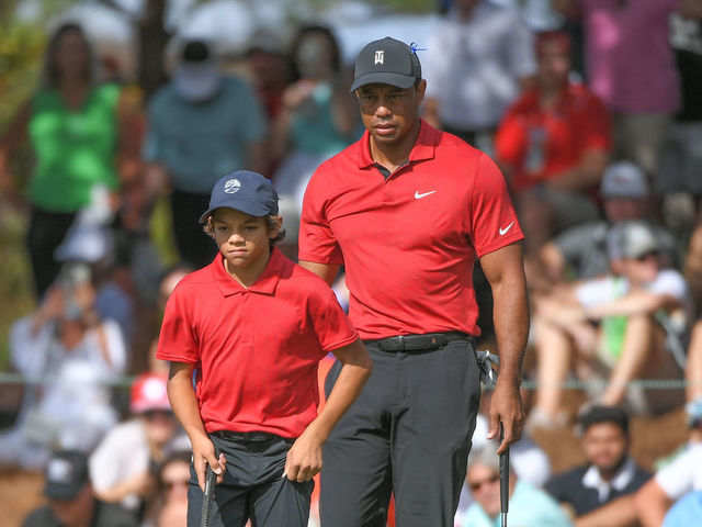 ORLANDO, FL - DECEMBER 19: Tiger Woods and his son, Charlie Woods, read the ninth green during the final round of the PGA TOUR Champions PNC Championship at Ritz-Carlton Golf Club on December 19, 2021 in Orlando, Florida.