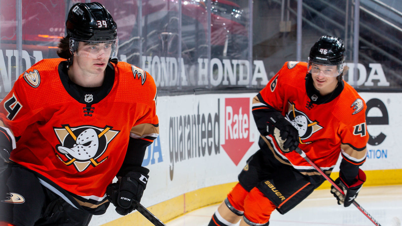ANAHEIM, CA - MARCH 18: Jamie Drysdale #34 of the Anaheim Ducks takes the ice while making his NHL debut in the game against the Arizona Coyotes as he is trailed by Trevor Zegras #46 before player introductions at Honda Center on March 18, 2021 in Anaheim, California.
