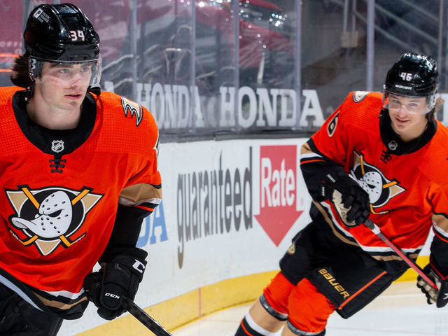 ANAHEIM, CA - MARCH 18: Jamie Drysdale #34 of the Anaheim Ducks takes the ice while making his NHL debut in the game against the Arizona Coyotes as he is trailed by Trevor Zegras #46 before player introductions at Honda Center on March 18, 2021 in Anaheim, California.