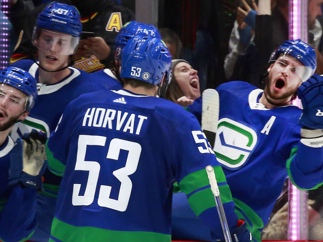 VANCOUVER, BC - DECEMBER 12: Bo Horvat #53 of the Vancouver Canucks is congratulated by teammates after scoring during their NHL game against the Columbus Blue Jackets at Rogers Arena December 12, 2021 in Vancouver, British Columbia, Canada. "n