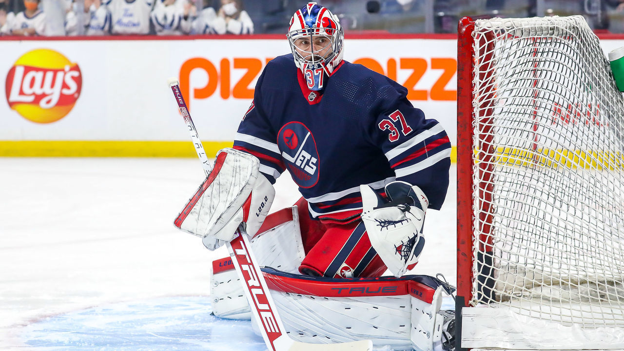 WINNIPEG, MB - DECEMBER 17: Goaltender Connor Hellebuyck #37 of the Winnipeg Jets takes part in the pre-game warm up prior to NHL action against the Washington Capitals at the Canada Life Centre on December 17, 2021 in Winnipeg, Manitoba, Canada.