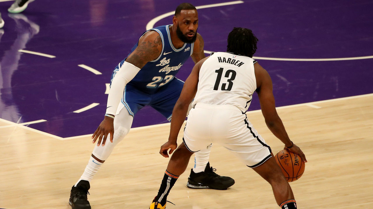 LOS ANGELES, CALIFORNIA - FEBRUARY 18: James Harden #13 of the Brooklyn Nets dribbles the ball against LeBron James #23 of the Los Angeles Lakers during the first quarter at Staples Center on February 18, 2021 in Los Angeles, California.